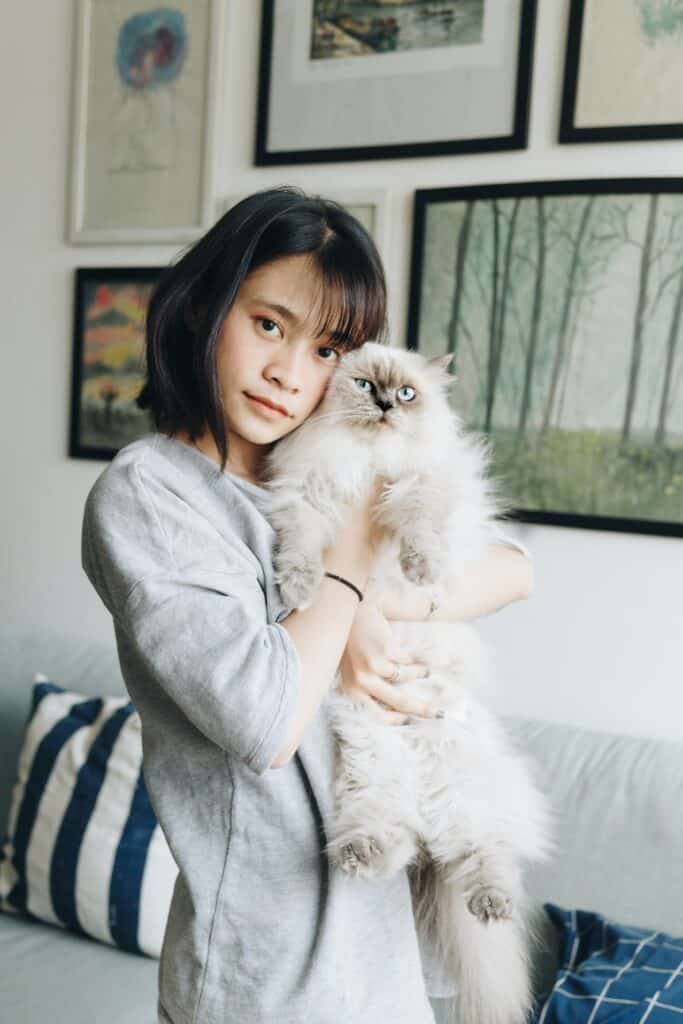 Asian girl hugging cat
